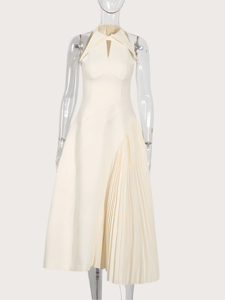 Chic pleated dress styled with heels for a wedding guest look